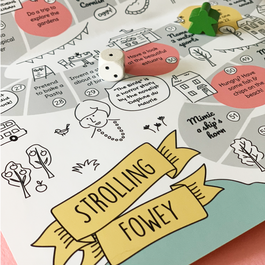 Fowey board game map detail with wooden dice and green marker.